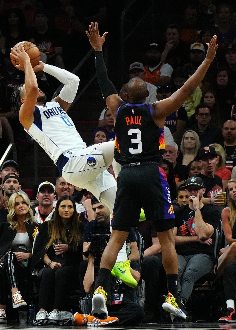 May 10, 2022; Phoenix, Arizona; USA; Mavericks guard Jalen Brunson (13) draws a foul on Suns guard Chris Paul (3) during game 5 of the second round of the Western Conference Playoffs.