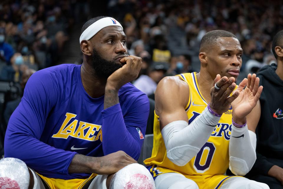 Los Angeles Lakers forward LeBron James (6, left) and guard Russell Westbrook (0) sit on the bench during the fourth quarter against the Sacramento Kings at Golden 1 Center.