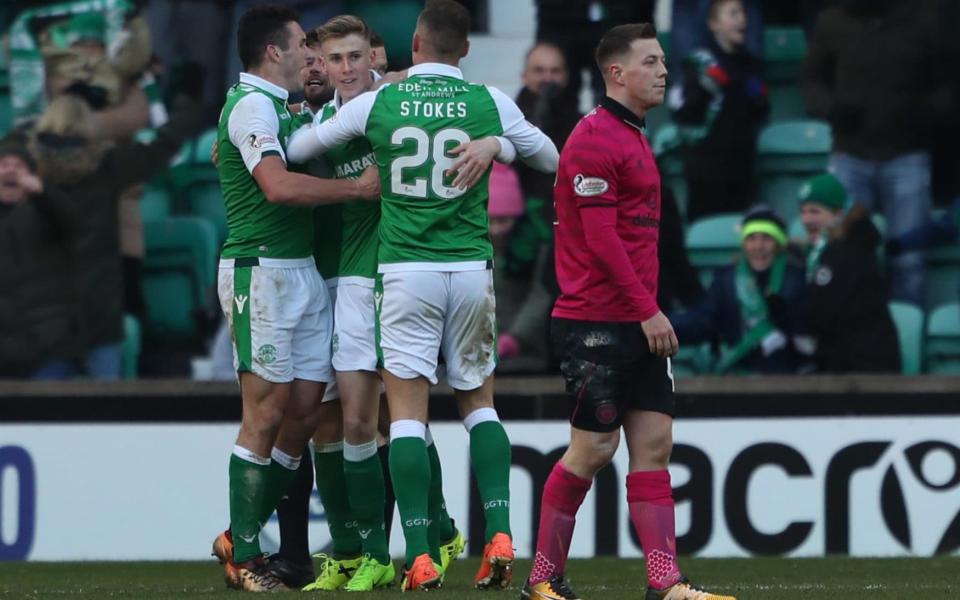 Oli Shaw and his team-mate celebrate after the Hibs forward grabbed his side's equaliser - PA