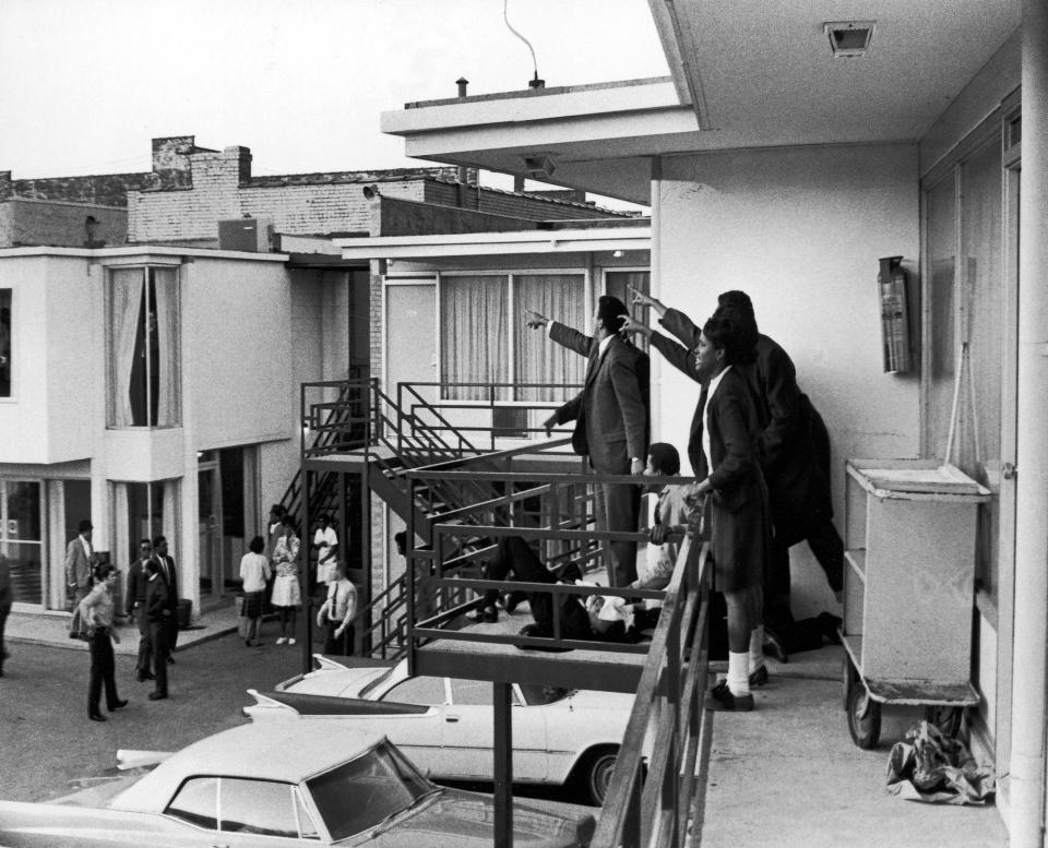 <p>Dr. Ralph Abernathy and Jesse Jackson (both obscured) and others stand on the balcony of the Lorraine Motel and point in the direction of gun shots that killed Dr. Martin Luther King Jr., who lies at their feet, Memphis, Tenn., April 4, 1968. (Photo: Joseph Louw/The LIFE Images Collection/Getty Images) </p>