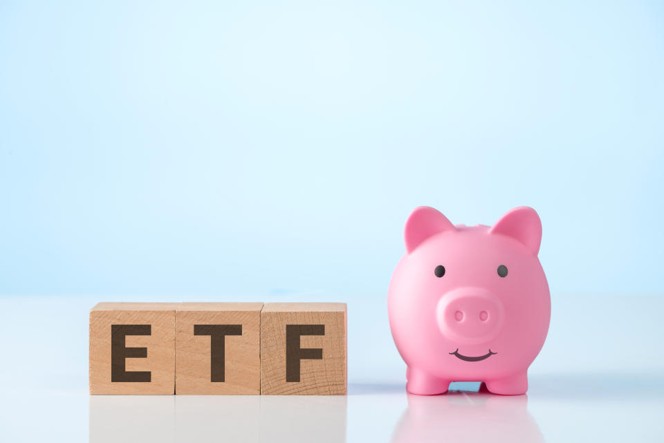 On the wooden cubes next to the piggy bank it says ETF. Exchange Traded Fund