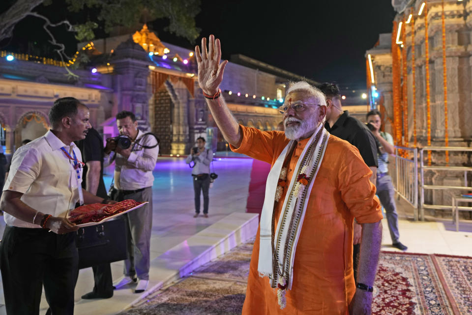 Indian Prime Minister Narendra Modi greets supporters at Kashi Vishwanath Temple after his roadshow in Varanasi, India, Monday, May 13, 2024. (AP Photo/Rajesh Kumar)