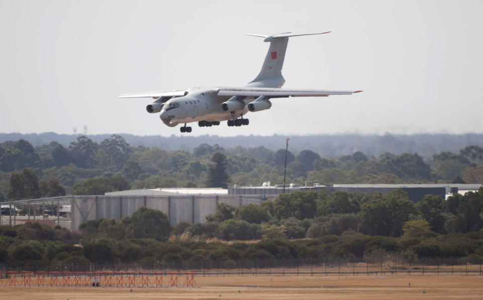 In this photo released by China's Xinhua news agency, a Chinese IL-76 plane searching for the missing Malaysia Airlines Flight MH370 returns to Perth airport, Australia after a hunting sortie, Monday, March 24, 2014. A Chinese plane on Monday spotted two white, square-shaped objects in an area identified by satellite imagery as containing possible debris from the missing Malaysian airliner, while the United States separately prepared to send a specialized device that can locate black boxes. The crew aboard an IL-76 plane sighted the object in the southern Indian Ocean and reported the coordinates to the Australian command center, which is coordinating the multinational search, as well as the Chinese icebreaker Snow Dragon, which is en route to the area, China's Xinhua News Agency reported. (AP Photo/Xinhua, Lui Siu Wai) NO SALES