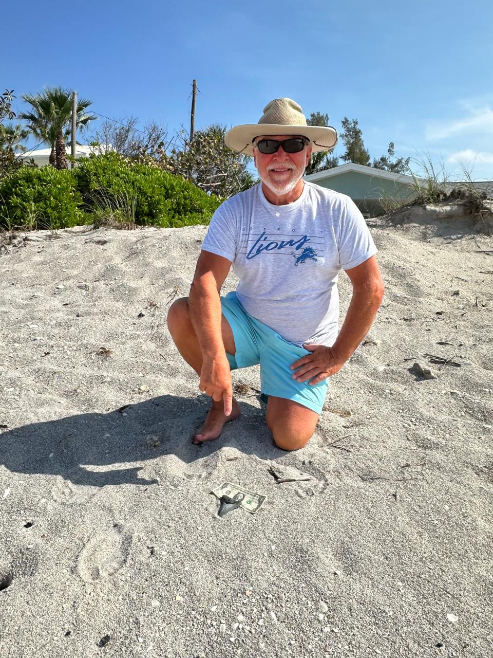 Brad Vanderstow points to the large Megalodon tooth he found on South Englewood beach near Stump Pass on March 6.