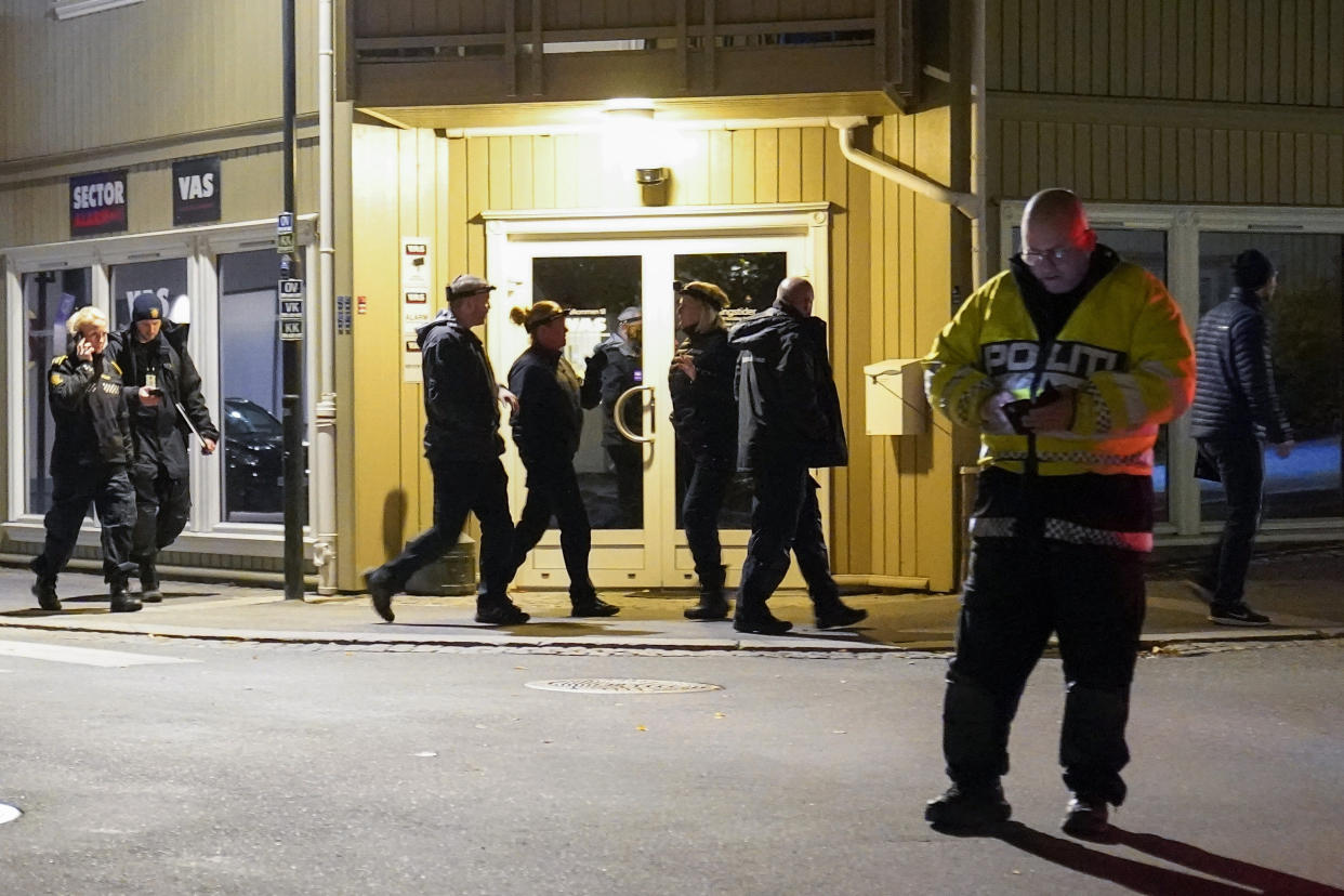 Police work at the scene where an arrow was shot into a wall in Kongsberg, Norway, Wednesday, Oct. 13, 2021. A man armed with a bow and arrows killed several people Wednesday near the Norwegian capital of Oslo before he was arrested, authorities said. (Torstein Bøe/NTB via AP)