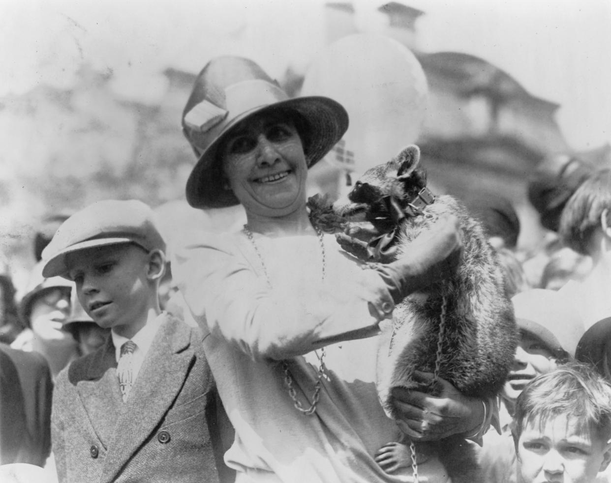 First Lady Grace Coolidge holds up her pet raccoon, Rebecca, for a crowd of children at the annual White House Easter Egg Roll, Washington DC, April 18, 1927. (Getty Images)