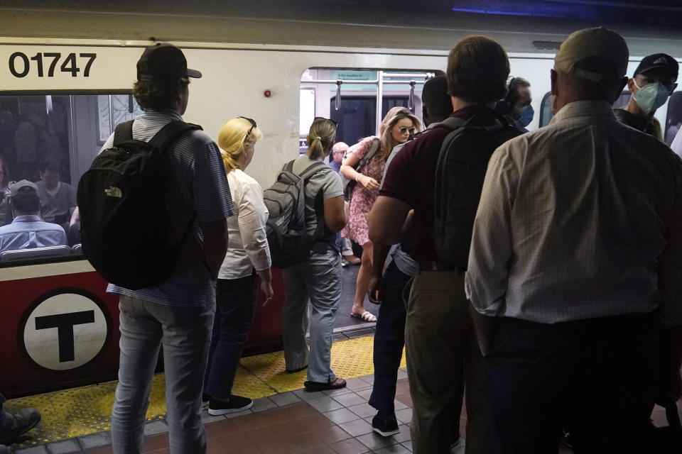 Commuters wait to load as a train of passengers arrives at the South Station Red Line subway stop, Wednesday, July 13, 2022, in Boston. Boston's public transit system is a mess, harried commuters and officials are increasingly looking to a Chinese-owned subway car manufacturer to account for some of the troubles. There have been fatal accidents, subway car collisions, malfunctioning elevators, and trains running on weekend schedules during rush hour. (AP Photo/Charles Krupa)