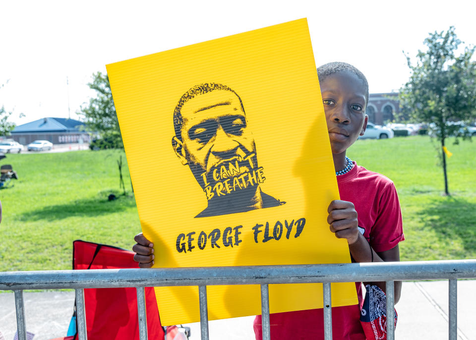 Engwin Williams, 10, awaits the passing of George Floyd's casket in Houston on June 9. | Ruddy Roye for TIME