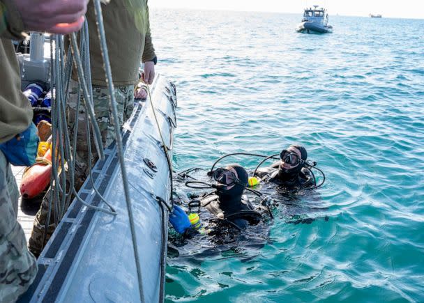 PHOTO: Sailors assigned to Explosive Ordnance Disposal Group 2 conduct pre-dive checks during recovery efforts of a high-altitude balloon in the Atlantic Ocean, Feb. 7, 2023. (Mass Communication Specialist 1st Class Ryan Seelbach/U.S. Navy)