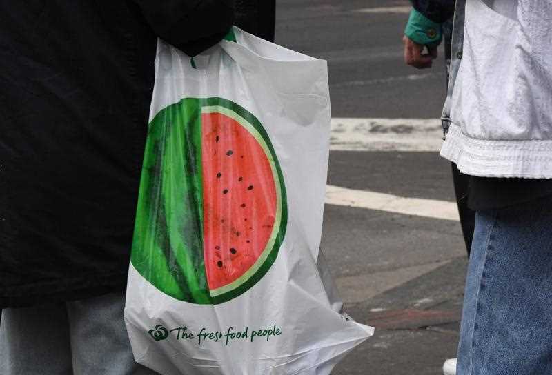 A shopper carries a reusable plastic bag at a Woolworths Sydney CBD store.
