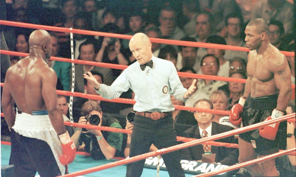 Referee Mills Lane steps between WBA heavyweight champion Evander Holyfield, left and challenger Mike Tyson during the third round of their fight in the MGM Grand Garden Arena on June 28, 1997.