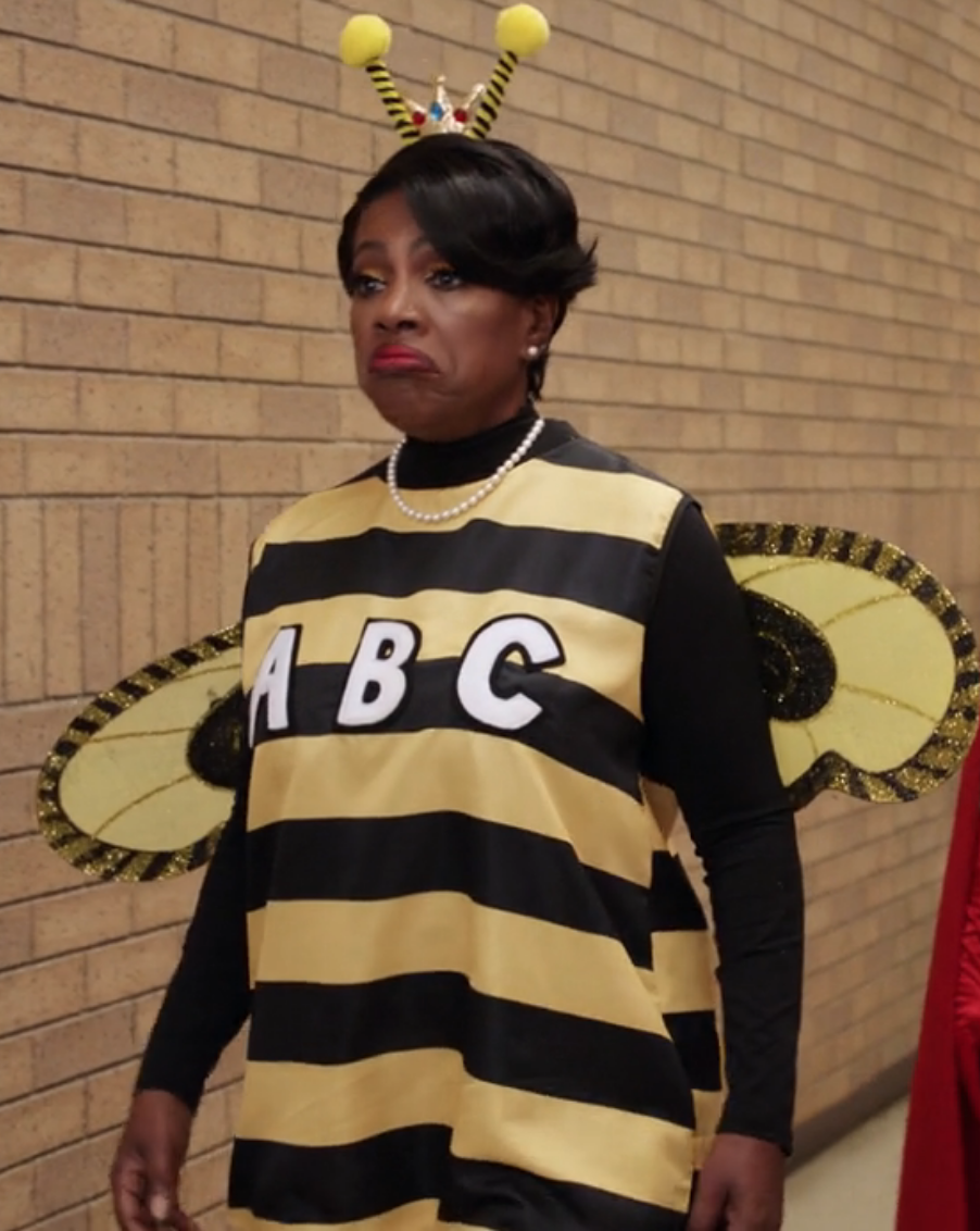 Barbara in a bee costume with wings with the letters "A,B,C" on the front
