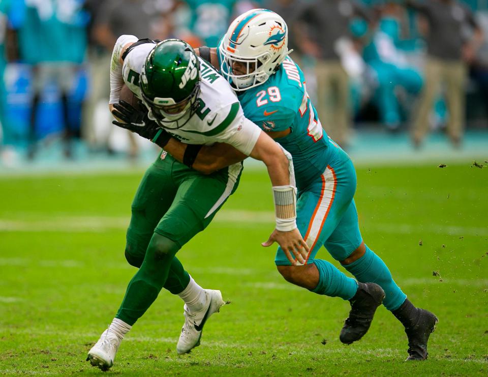 Miami Dolphins safety Brandon Jones (29)sacks New York Jets quarterback Zach Wilson (2) during second half action against the New York Jets during NFL game at Hard Rock Stadium Sunday in Miami Gardens. 