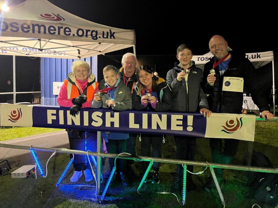 Lancashire Telegraph: Chris Regan with family and loved ones after completing Walk in the Dark 