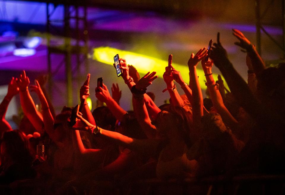 Festivalgoers put their hands up during a set by ODESZA during Splash House's After Hours party at the Palm Springs Air Museum in Palm Springs, Calif., Saturday, Aug. 12, 2023. 