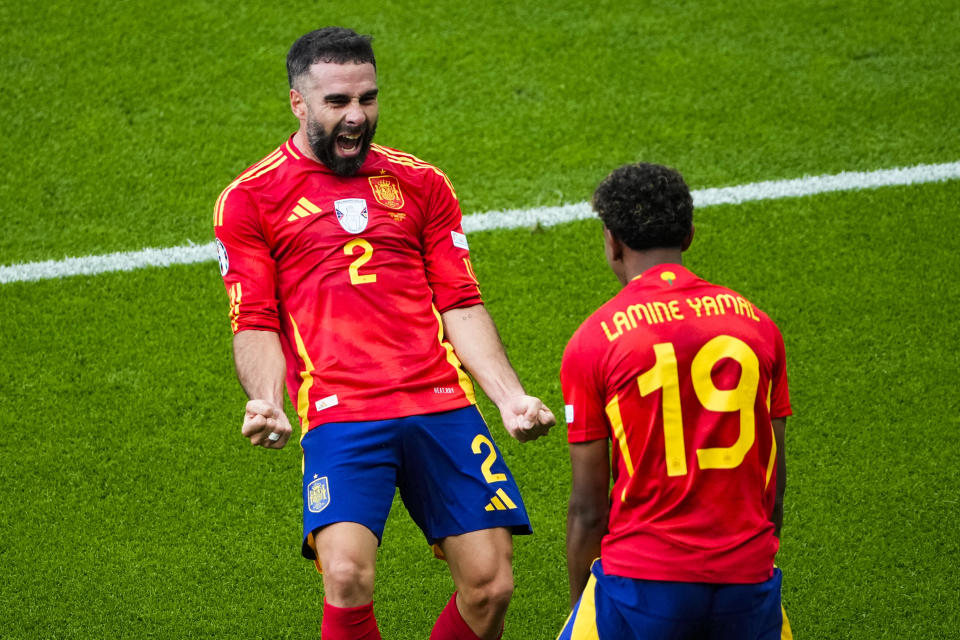 Spain's Dani Carvajal, left, celebrates with Spain's Lamine Yamal after scoring his side's third goal during a Group B match between Spain and Croatia at the Euro 2024 soccer tournament in Berlin, Germany, Saturday, June 15, 2024. (AP Photo/Petr Josek)