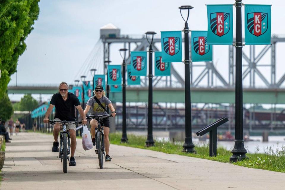 Cyclists ride along the Berkley Riverfront. The trail will be extended to the West Bottoms.