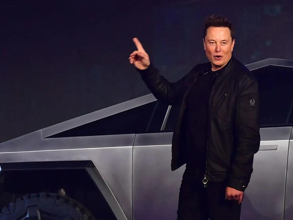 Elon Musk in front of a Cybertruck
