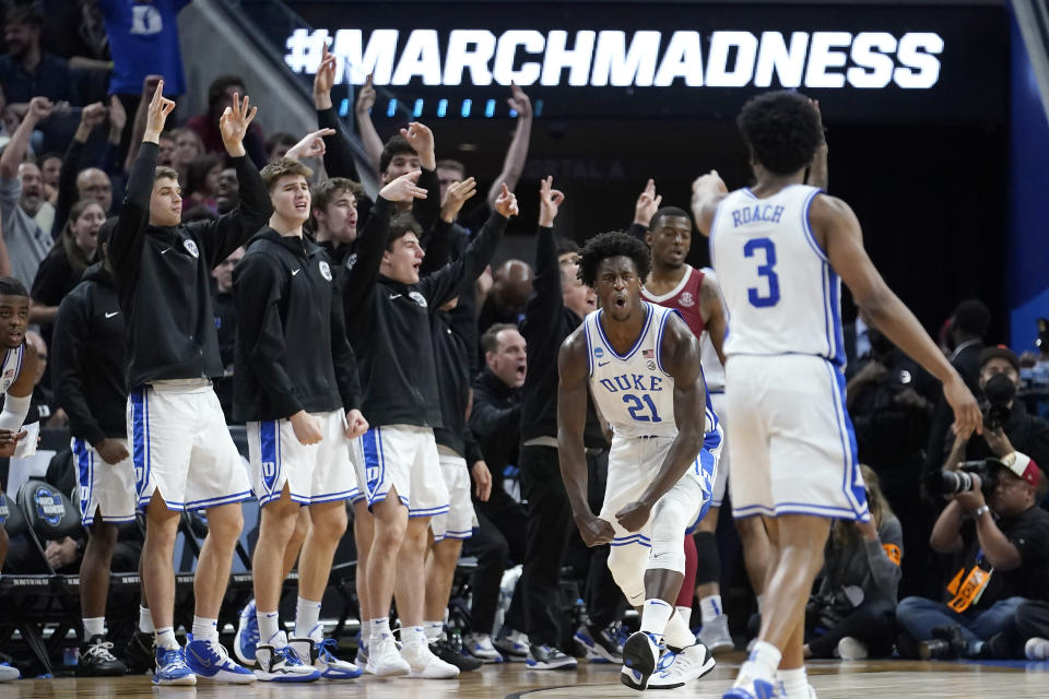 Duke forward AJ Griffin (21) celebrates in front of teammates on the bench after shooting a three point basket against Arkansas during the second half of a college basketball game in the Elite 8 round of the NCAA men's tournament in San Francisco, Saturday, March 26, 2022. (AP Photo/Marcio Jose Sanchez)