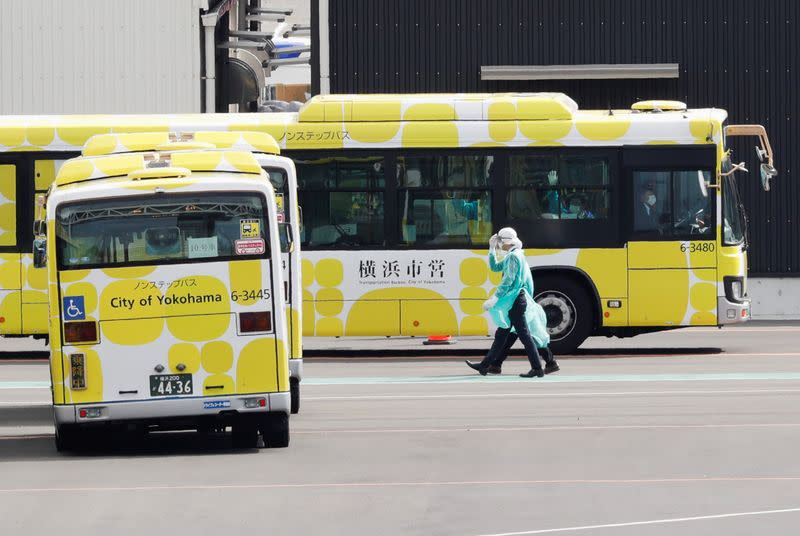 Buses to transport passengers from the cruise ship Diamond Princess, seen at Daikoku Pier Cruise Terminal in Yokohama, south of Tokyo