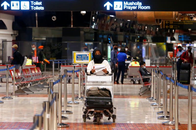 A passenger walks to have her documents checked at a Soekarno Hatta Airport amid the coronavirus disease (COVID-19) outbreak