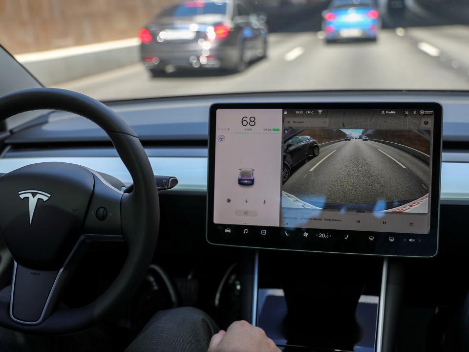 The interior of a Tesla driving down the highway