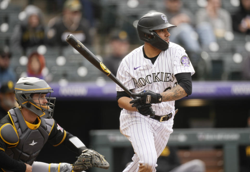 Colorado Rockies' Harold Castro follows the flight of his RBI-single off Pittsburgh Pirates relief pitcher Yohan Ramirez in the eighth inning of a baseball game Wednesday, April 19, 2023, in Denver. (AP Photo/David Zalubowski)