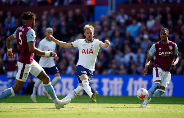 Harry Kane, centre, shoots at the Aston Villa goal