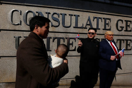 Howard, 37, an Australian-Chinese who is impersonating North Korean leader Kim Jong-un, and Dennis Alan of Chicago, 66, who is impersonating U.S. President Donald Trump, pose outside U.S. Consulate in Hong Kong, China January 25, 2017. REUTERS/Bobby Yip