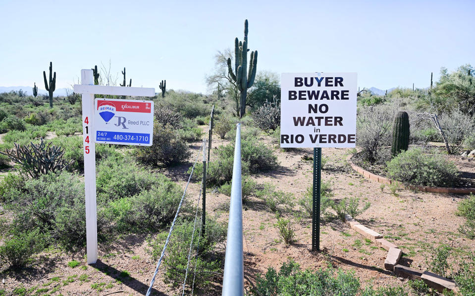 A sign warning buyers of the water situation is displayed across from a property for sale in Rio Verde Foothills, Arizona, on February 24, 2023. - Homes in fast-growing Rio Verde Foothills have never had running water -- there are no mains pipes -- so the 500 households without access to their own wells bought tankerloads from Scottsdale. But the neighboring city of Scottsdale decided it could no longer afford to sell its dwindling supply from the Colorado River, as a decades-long drought bites the American West. (Photo by Frederic J. BROWN / AFP) (Photo by FREDERIC J. BROWN/AFP via Getty Images)