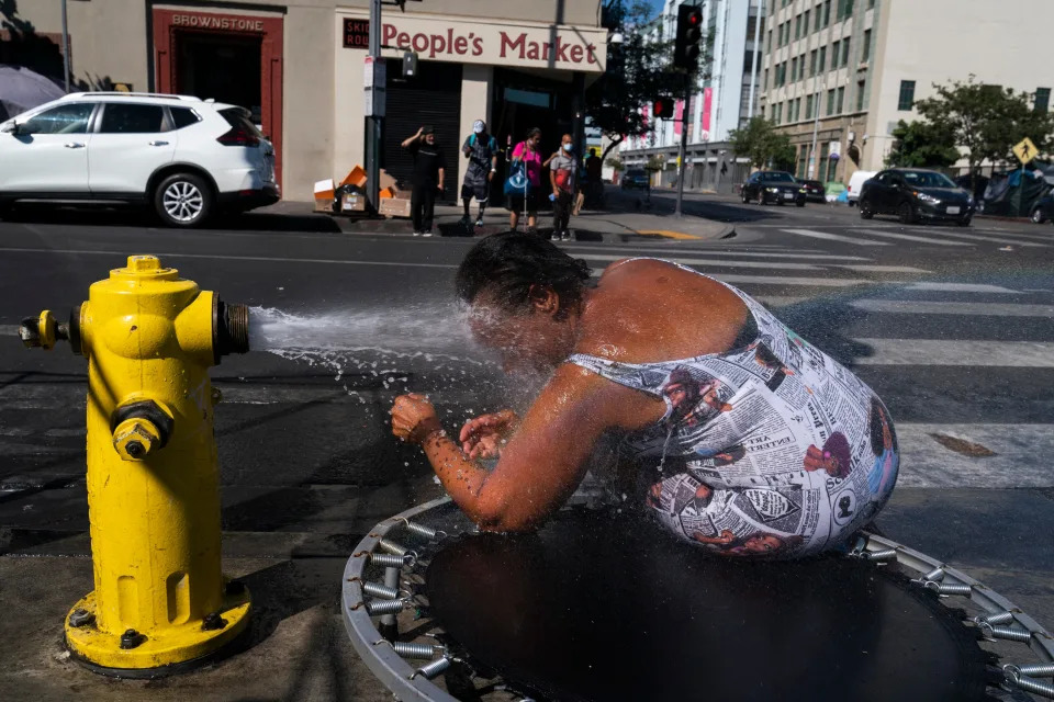 Stephanie Williams, 60, cools off with water from a hydrant in the Skid Row area of Los Angeles, Wednesday. Excessive-heat warnings expanded to all of Southern California and northward into the Central Valley on Wednesday, and were predicted to spread into Northern California later in the week.