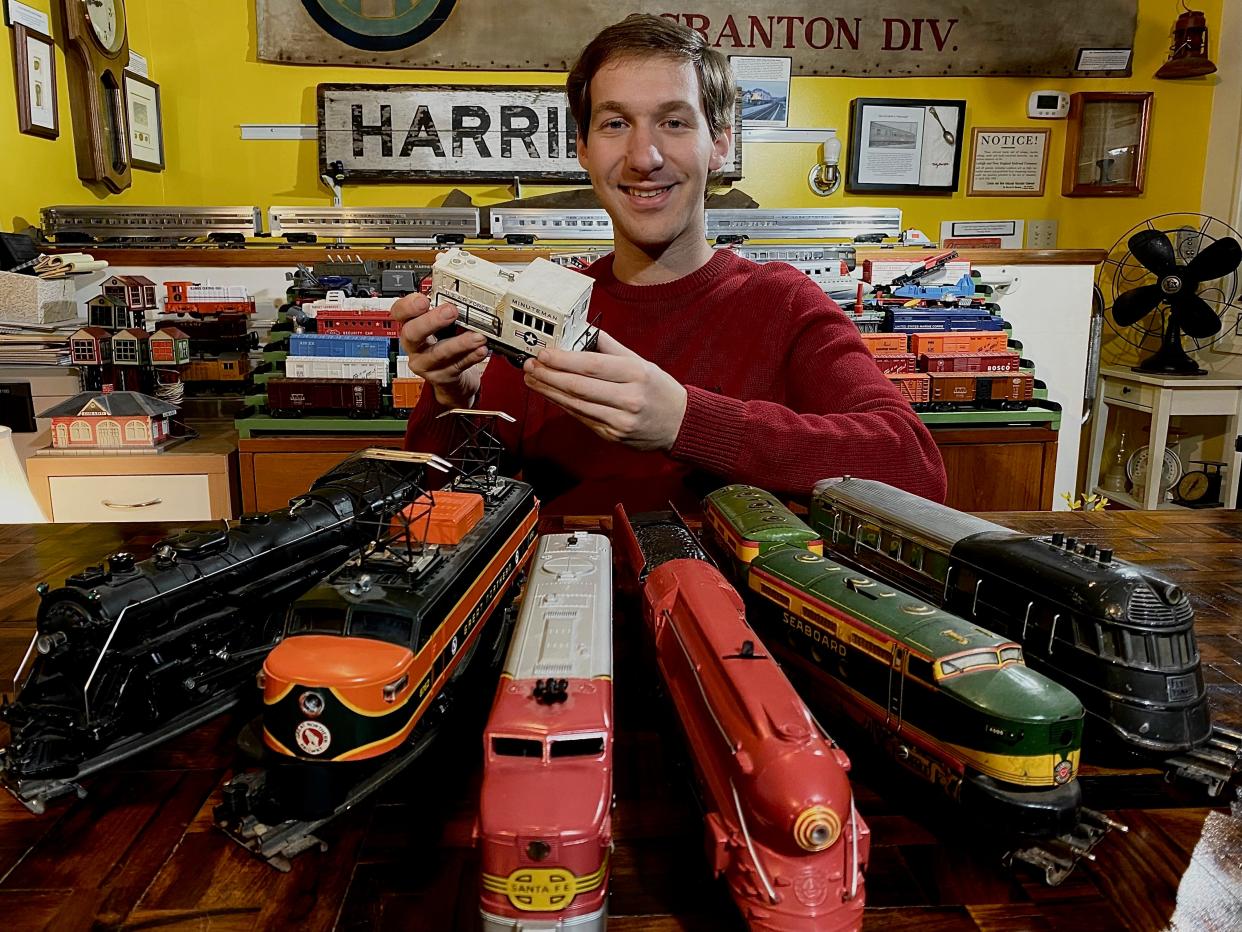 Alex Prizgintas, President of the Woodbury Historical Society, holds some toy trains that will be featured at the Woodbury Historical Society of Highland Mills Train Show on Dec. 3 in Highland Mills. The show will feature four operating train tables and more.