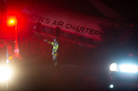 A fireman directs a truck at the scene of a plane crash outside South Africa's capital Pretoria, South Africa, July 10,2018. REUTERS/Yeshiel Panchia