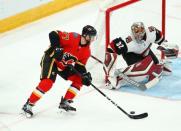 Nov 25, 2018; Glendale, AZ, USA; Calgary Flames center Mark Jankowski (77) scores a goal against Arizona Coyotes goalie Antti Raanta (32) in the third period at Gila River Arena. Mandatory Credit: Mark J. Rebilas-USA TODAY Sports