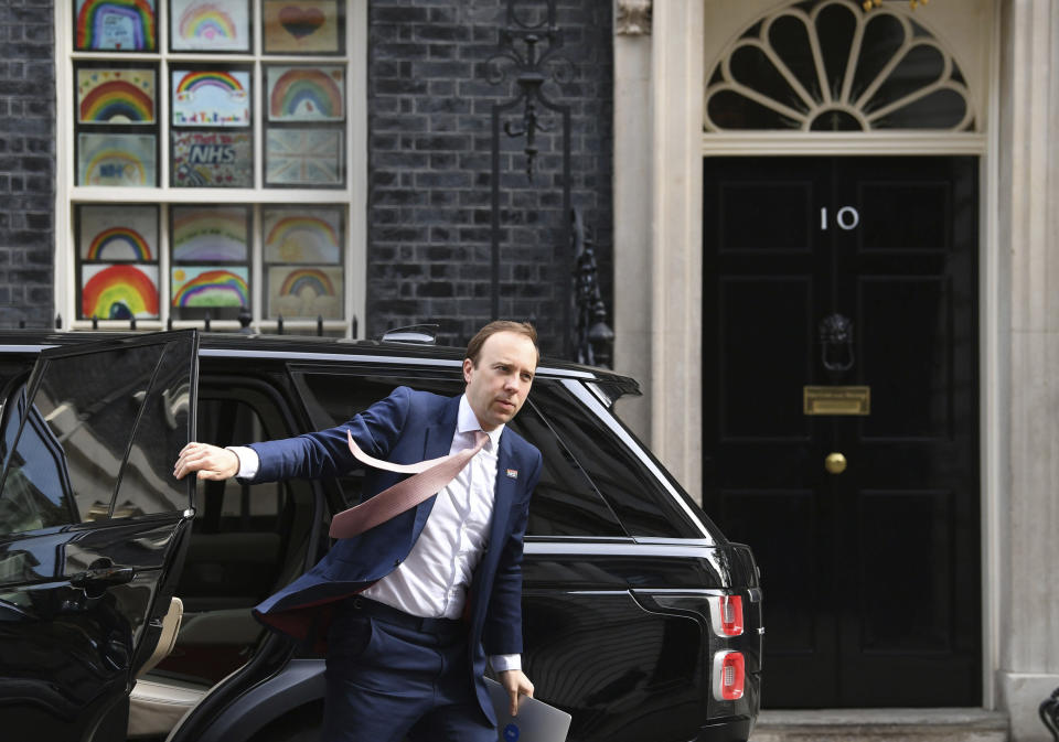 Britain's Health Secretary Matt Hancock arrives in Downing Street, as the UK enters a seventh week of lockdown to help stop the spread of coronavirus, in London, Tuesday May 5, 2020. The rainbow image in in window behind has been adopted nationally as a symbol to thank care workers on the front line to fight the highly contagious COVID-19 coronavirus. (Stefan Rousseau / PA via AP)