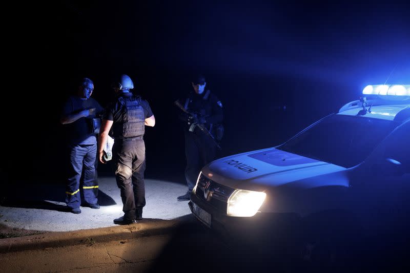 Ukrainian police officers patrol the city of Kramatorsk at night time