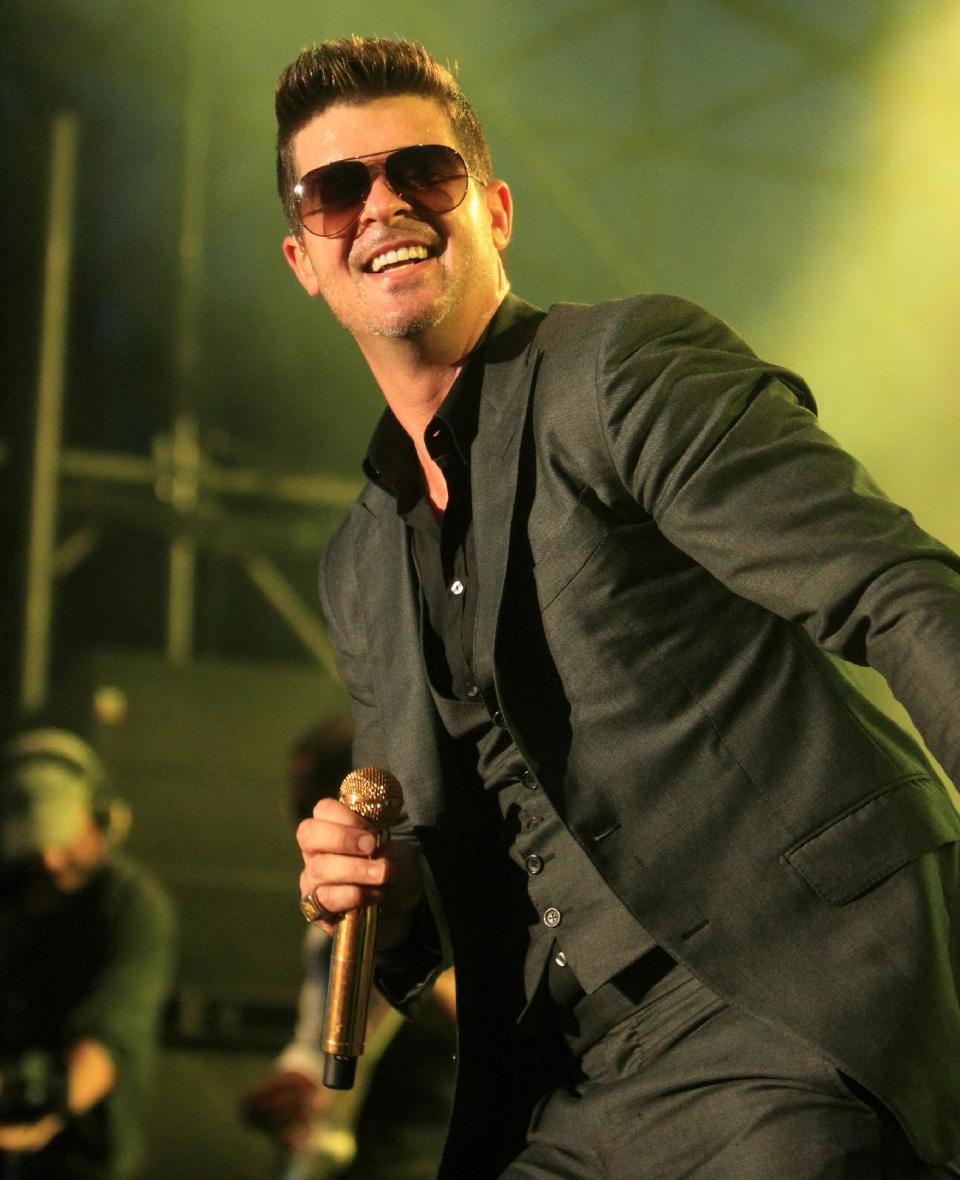 FILE - This Sept. 21, 2013 file photo shows Robin Thicke performing during the 2013 Virgin Mobile FreeFest at Merriweather Post Pavilion in Columbia, Md. Nielsen Entertainment announced late Tuesday, Jan. 7, 2014, that Thicke's ubiquitous "Blurred Lines" was the best-selling song with 6.4 million tracks sold. (Photo by Owen Sweeney/Invision/AP, File)