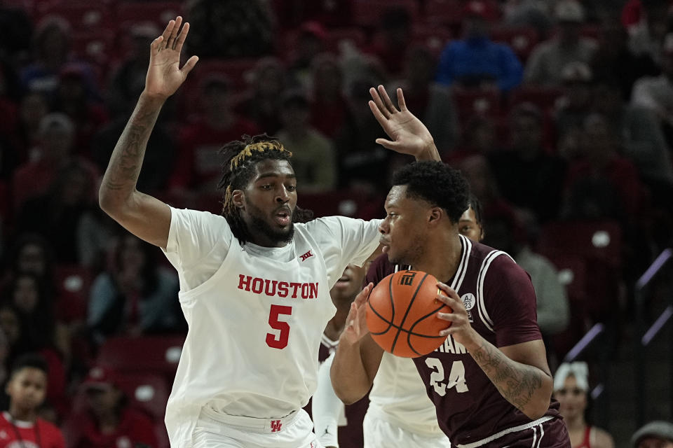 Houston forward Ja'Vier Francis (5) defends Montana forward Dischon Thomas (24) during the first half of an NCAA college basketball game, Friday, Nov. 24, 2023, in Houston. (AP Photo/Kevin M. Cox)