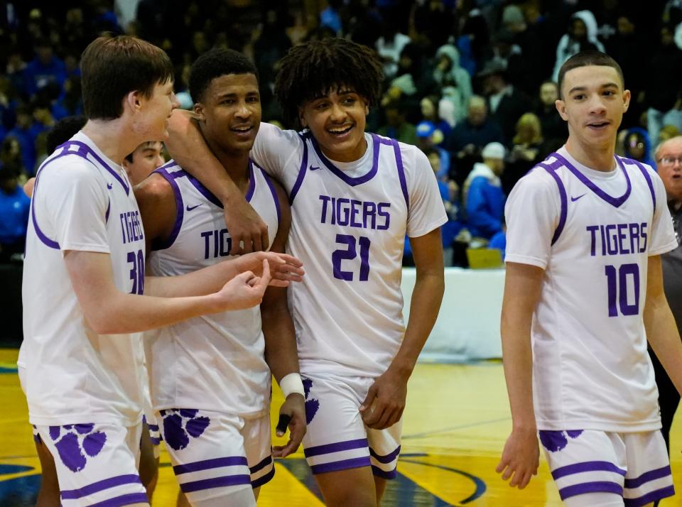 Pickerington Central’s Devin Royal (21) embraces teammate Sonny Styles (24) as they walk off the court with teammates Gavin Headings (30) and Andrew Hedgepeth (10) following their 59-42 win against the Gahanna Lincoln Lions during a OHSAA Boys' Basketball regional final at Ohio Dominican University Alumni Hall.