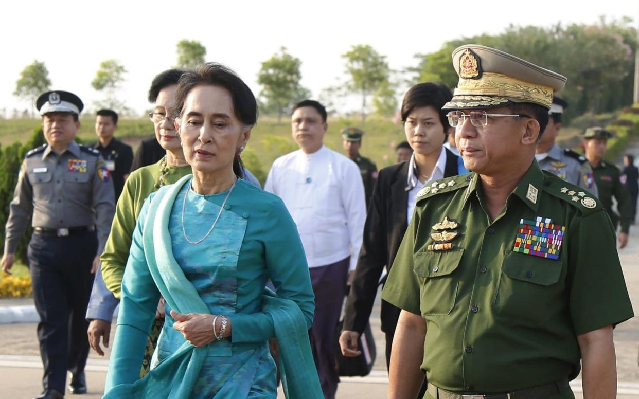 Senior General Min Aung Hlaing (R) and Myanmar Foreign Minister and State Counselor Aung San Suu Kyi (L) arrive to Naypyitaw International Airport in Naypyitaw, Myanmar - HEIN HTET/Shutterstock