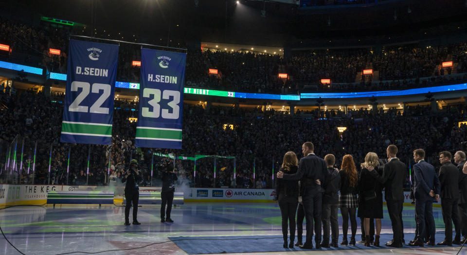 Daniel and Henrik Sedin, two of the greatest players to ever lace 'em up for the Vancouver Canucks, watched their numbers go into the rafters on Wednesday night. (Photo by Ben Nelms/Getty Images)