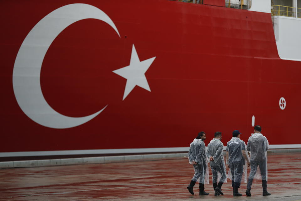 Turkish police officers patrol the dock, backdropped by the drillship 'Yavuz' scheduled to be dispatched to the Mediterranean, at the port of Dilovasi, outside Istanbul, Thursday, June 20, 2019. Turkish officials say the drillship Yavuz will be dispatched to an area off Cyprus to drill for gas. The Cyprus government says Turkey’s actions contravene international law and violate Cypriot sovereign rights. AP Photo/Lefteris Pitarakis)