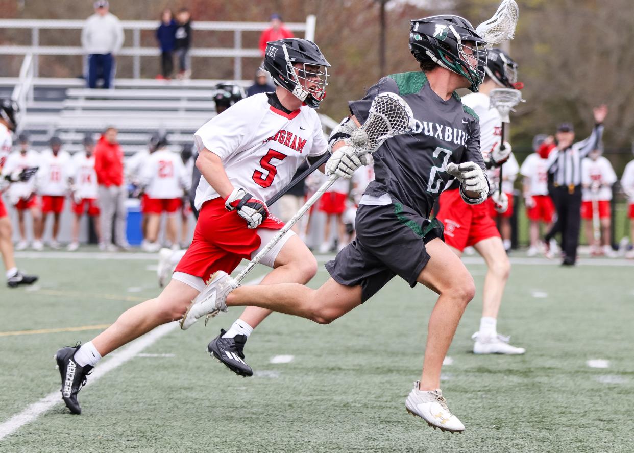 Duxbury's Sam Wien is defended by Hingham's Tanner Whitehouse during a game at Hingham High School on Tuesday, April 30, 2024.