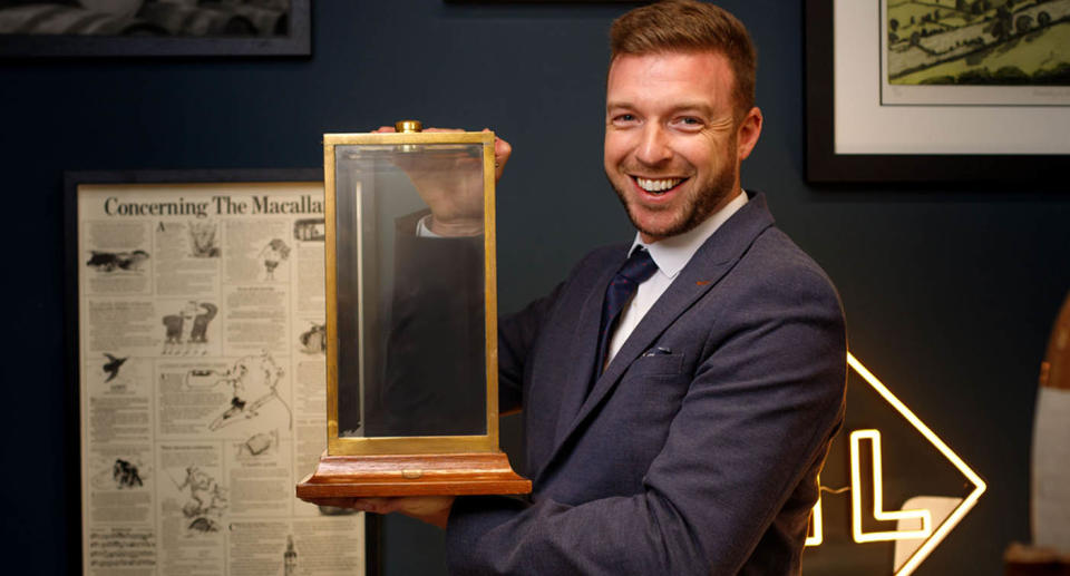 Valuer Mark Littler holding the valuable whisky case. Source: Jam Press