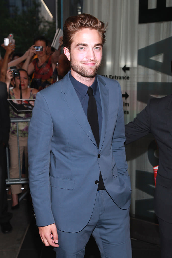 Robert Pattinson puts on a (somewhat) happy face for the cameras as he steps out for the first time since Kristen-Rupert-gate. While attending the Red Carpet premiere for David Cronenberg’s indie flick “Cosmopolis” at the Museum of Modern Art in Manhattan, Pattinson sports a beautifully tailored Gucci suit, looking every bit the billionaire he plays in the film. The streets were lined with screaming Twihards, who screamed out their support at Beatles-like decibels. “Cosmopolis” opens in limited release this Friday, August 17.