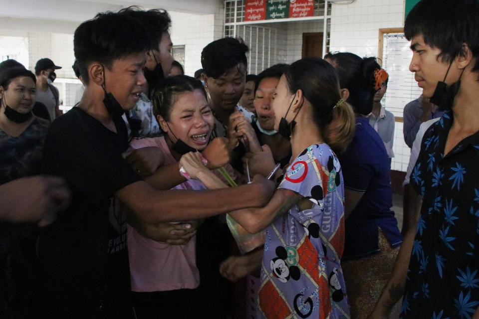 People mourn over the death of a man who was killed during a clash with Myanmar's security forces, during his cremation in Yangon, Myanmar, Monday, March 29, 2021. Over 100 people across the country were killed by security forces on Saturday alone, including several children — a toll that has prompted a U.N. human rights expert to accuse the junta of committing “mass murder” and to criticize the international community for not doing enough to stop it. (AP Photo)