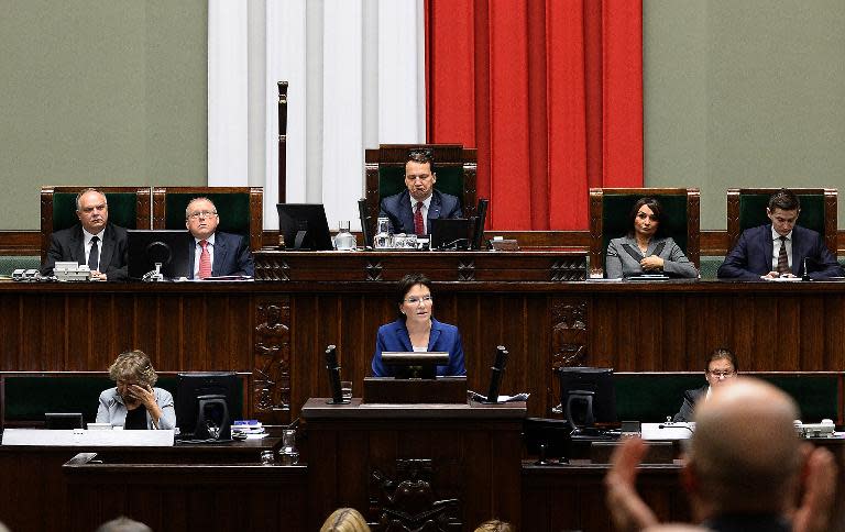 Poland's Prime Minister Ewa Kopacz (C, front) gives her inaugural speech to parliament, in front of Radoslaw Sikorski (C, back), speaker of the parliament, on October 1, 2014 in Warsaw