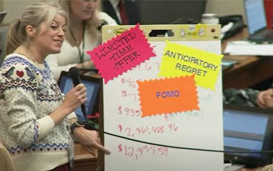 At-large Council member Quin Evans-Segall explains her opposition to a proposal for upgraded Tasers using a whiteboard visual on Tuesday, Dec. 5, 2023.