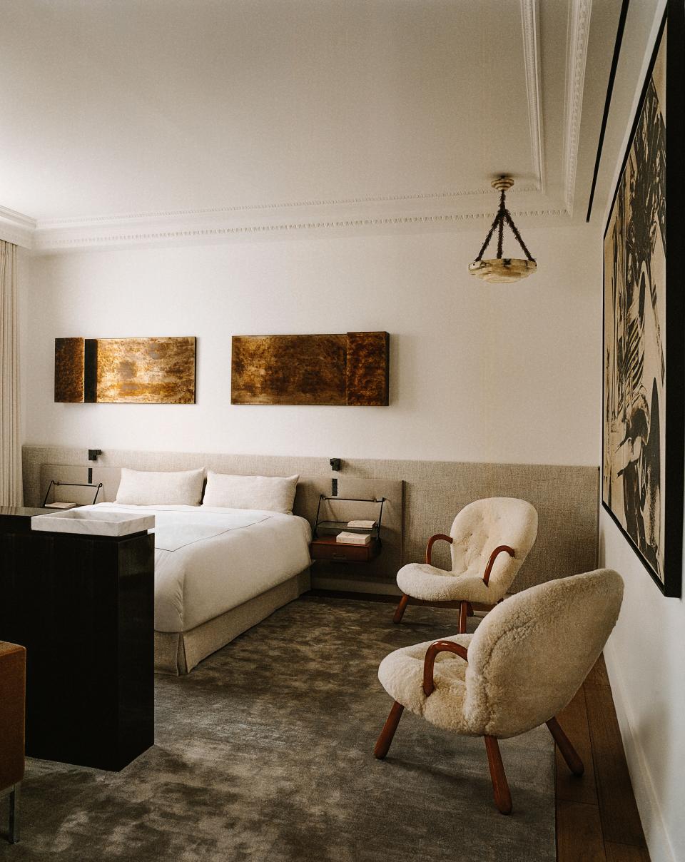 In the primary bedroom a vintage alabaster ceiling light from Milan’s Nilufar gallery floats above a pair of Philip Arctander armchairs. Above bed, wall lamps by Dimorestudio; vintage bedside tables by Silvio Cavatorta; reading lamps by Ozone from the Invisible collection.