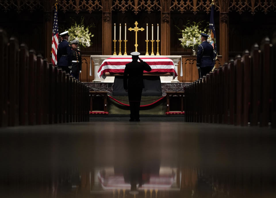 People pay their respects as the flag-draped casket of former President George H.W. Bush lies in repose at St. Martin's Episcopal Church Wednesday, Dec. 5, 2018, in Houston. (AP Photo/David J. Phillip, Pool)